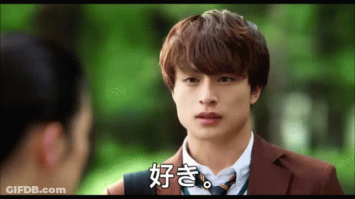 A Man In A Suit And Tie Talks To A Woman In A Park GIF