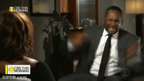 A Man In A Suit And Tie Talks To A Woman On Cbs This Morning GIF