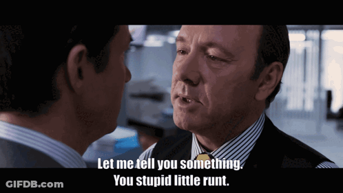A Man In A Suit And Tie Talks To Another Man With The Words Let Me Tell You Something You Stupid Little Runt GIF
