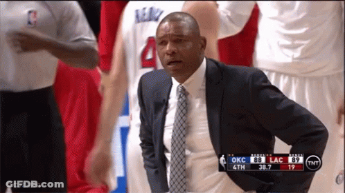 A Man In A Suit And Tie Watches A Basketball Game GIF