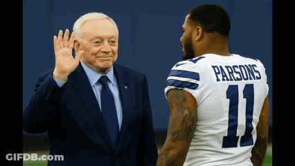 A Man In A Suit And Tie Waves To A Man In A Number 11 Parsons Jersey GIF