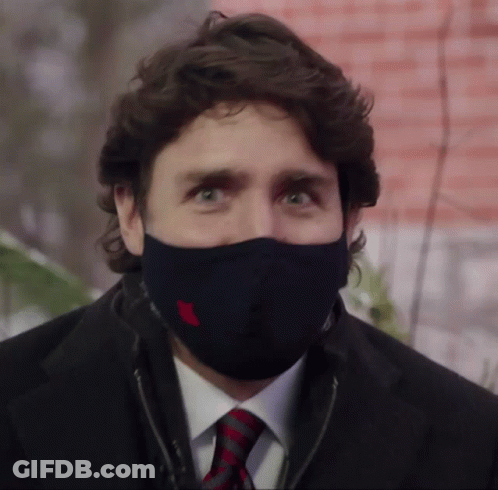 A Man In A Suit And Tie Wearing A Black Mask GIF