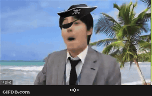 A Man In A Suit And Tie Wearing A Pirate Hat And Eye Patch GIF