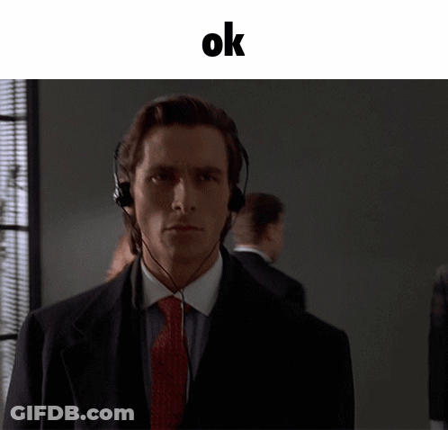 A Man In A Suit And Tie Wearing Headphones With The Word Ok Above Him GIF