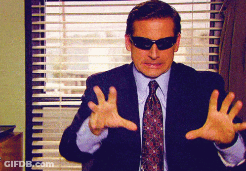 A Man In A Suit And Tie Wearing Sunglasses GIF