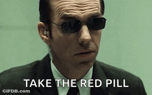 A Man In A Suit And Tie Wearing Sunglasses Says Take The Red Pill GIF