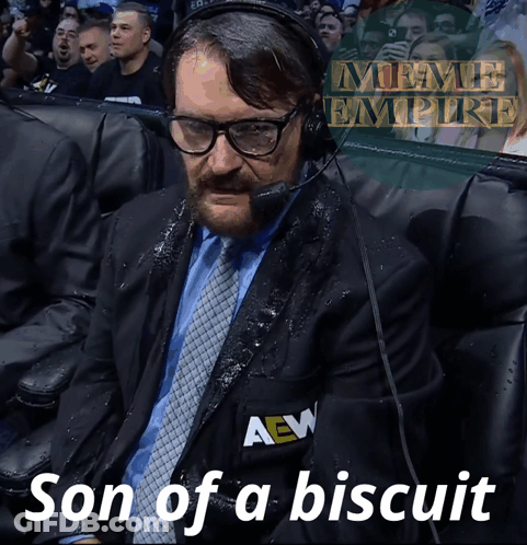 A Man In A Suit And Tie With A Aew Logo On His Jacket GIF