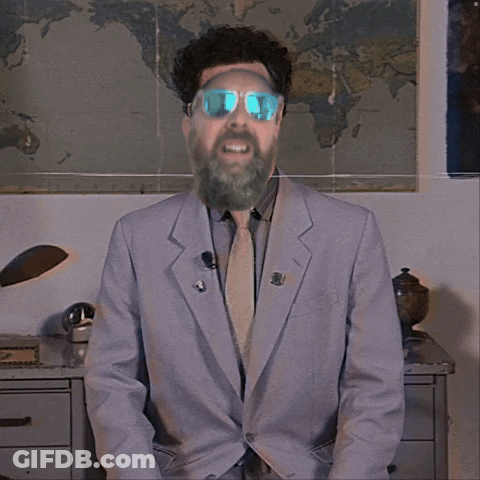 A Man In A Suit And Tie With A Beard Wearing Sunglasses GIF