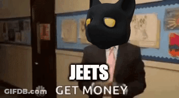 A Man In A Suit And Tie With A Black Cat On His Head And The Words Jeets Get Money Above Him GIF