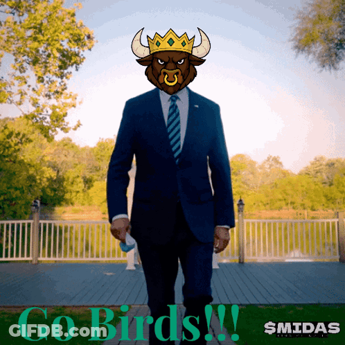 A Man In A Suit And Tie With A Bull 'S Head And The Words Go Birds GIF