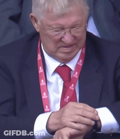 A Man In A Suit And Tie With A Lanyard That Says Emirates GIF