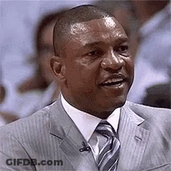 A Man In A Suit And Tie With A Microphone In His Ear . GIF