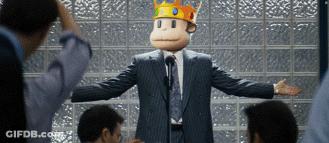 A Man In A Suit And Tie With A Monkey Mask On His Head GIF
