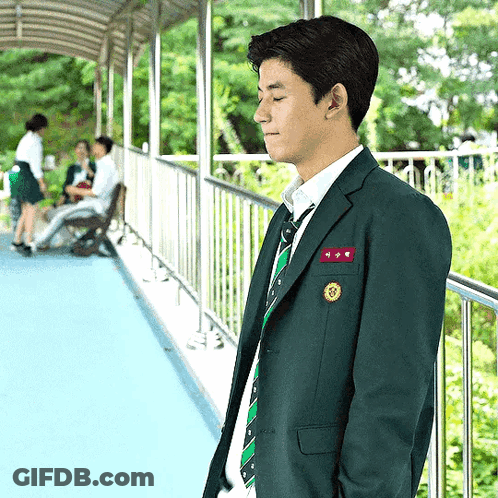 A Man In A Suit And Tie With A Name Tag That Says ' A ' GIF