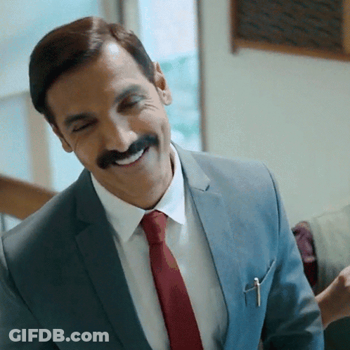 A Man In A Suit And Tie With A Pen In His Pocket GIF