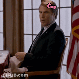 A Man In A Suit And Tie With A Pink Hello Kitty Bow On His Head GIF