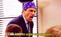 A Man In A Suit And Tie With A Purple Bandana On His Head Is Screaming At Someone . GIF