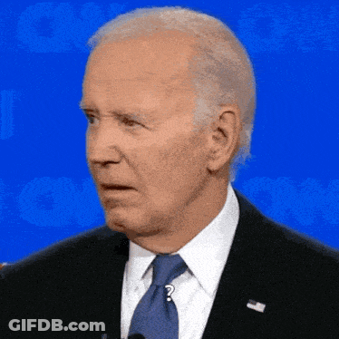 A Man In A Suit And Tie With A Question Mark On His Necktie GIF