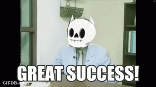 A Man In A Suit And Tie With A Skull On His Head Says Great Success . GIF