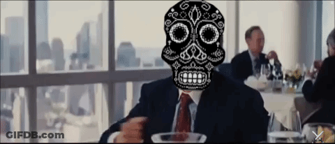 A Man In A Suit And Tie With A Sugar Skull On His Face GIF
