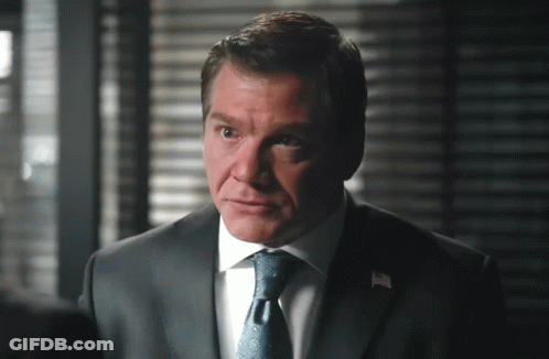 A Man In A Suit And Tie With A White Shirt GIF