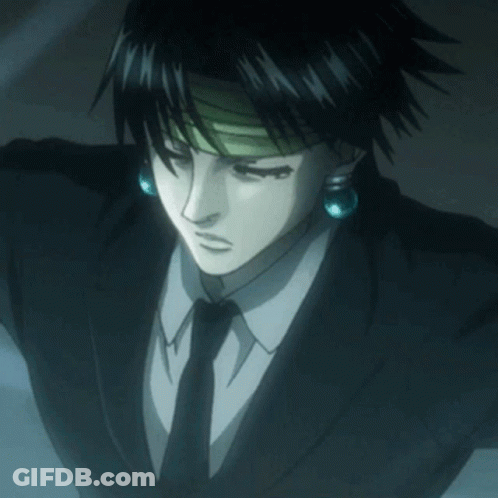 A Man In A Suit And Tie With Blue Earrings On His Ears GIF
