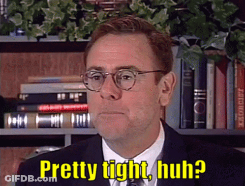 A Man In A Suit And Tie With Glasses Says Pretty Tight Huh GIF