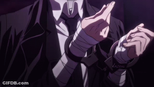 A Man In A Suit And Tie With Handcuffs On His Wrists And The Name Dazxu On The Bottom GIF