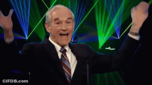 A Man In A Suit And Tie With His Arms In The Air And The Words It 'S Happening Above Him GIF
