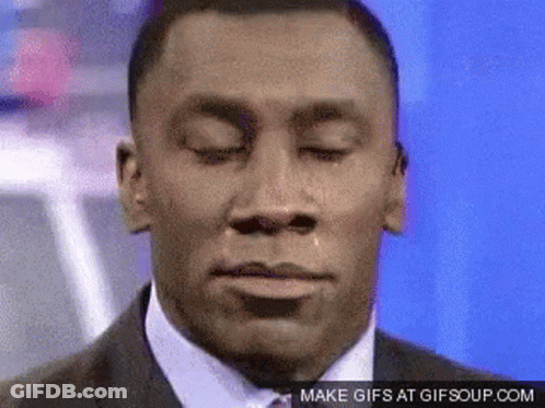 A Man In A Suit And Tie With His Eyes Closed GIF