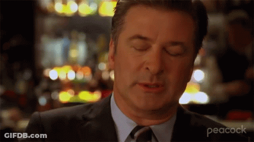 A Man In A Suit And Tie With His Eyes Closed GIF