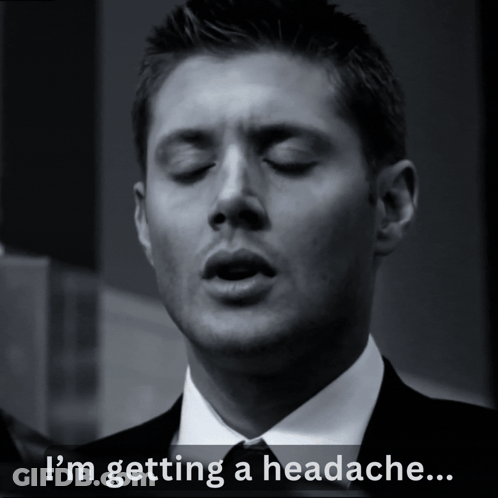 A Man In A Suit And Tie With His Eyes Closed Says " I 'M Getting A Headache " GIF