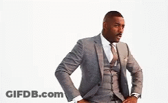 A Man In A Suit And Tie With His Hands On His Hips . GIF