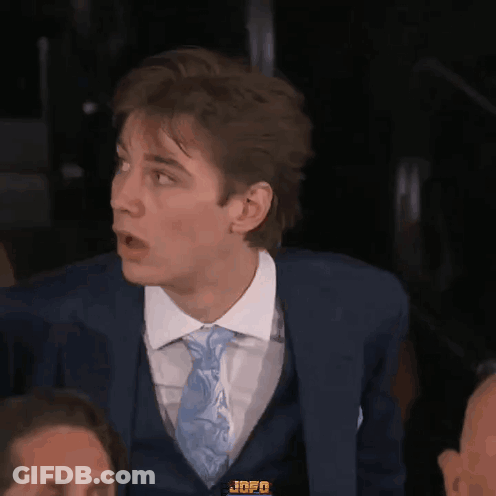 A Man In A Suit And Tie With Jnfo On His Chest GIF