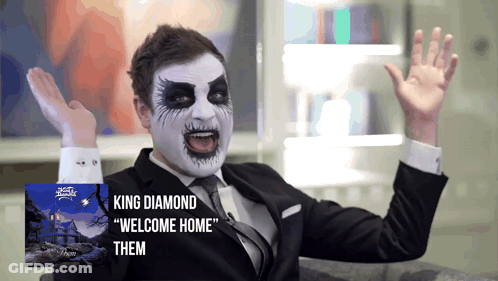 A Man In A Suit And Tie With King Diamond Welcome Home Them Written On The Bottom GIF