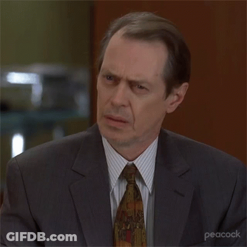 A Man In A Suit And Tie With Peacock Written On The Bottom Right Corner GIF