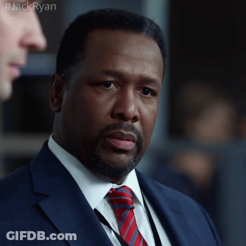 A Man In A Suit And Tie With The Hashtag #Jackryan On The Bottom GIF