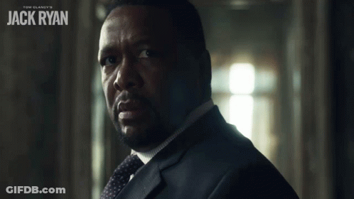 A Man In A Suit And Tie With The Name Jack Ryan On The Bottom GIF