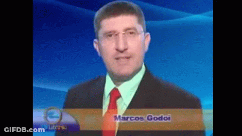 A Man In A Suit And Tie With The Name Marcos Godoi On The Bottom Right GIF