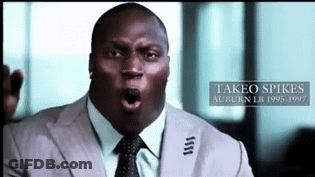 A Man In A Suit And Tie With The Name Takeo Spikes On The Bottom Right GIF