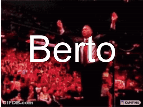 A Man In A Suit And Tie With The Word Berto Written On His Face GIF