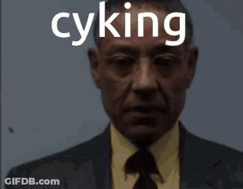 A Man In A Suit And Tie With The Word Cyking On His Face GIF