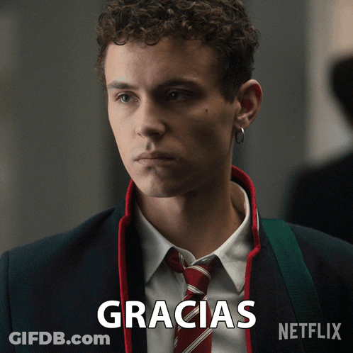 A Man In A Suit And Tie With The Word Gracias Written Below Him GIF