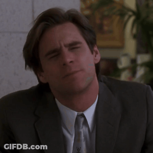 A Man In A Suit And Tie With The Word No On His Face GIF