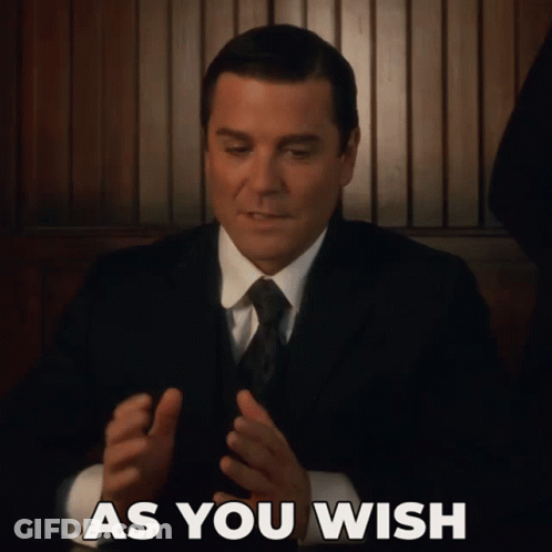 A Man In A Suit And Tie With The Words As You Wish Above Him GIF
