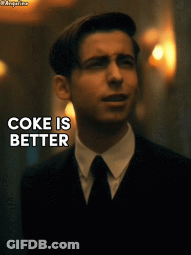 A Man In A Suit And Tie With The Words Coke Is Better GIF