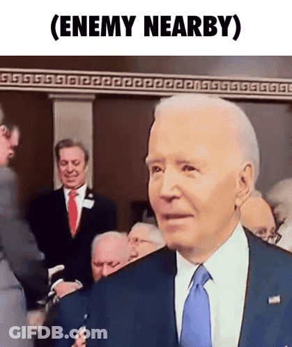 A Man In A Suit And Tie With The Words Enemy Nearby Written Below Him GIF