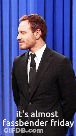 A Man In A Suit And Tie With The Words It 'S Almost Fassbender Friday Below Him GIF
