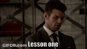 A Man In A Suit And Tie With The Words Lesson One On His Face GIF