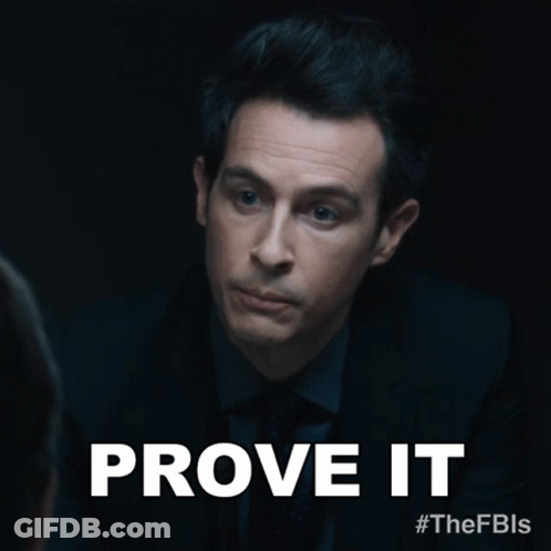 A Man In A Suit And Tie With The Words Prove It Above Him GIF